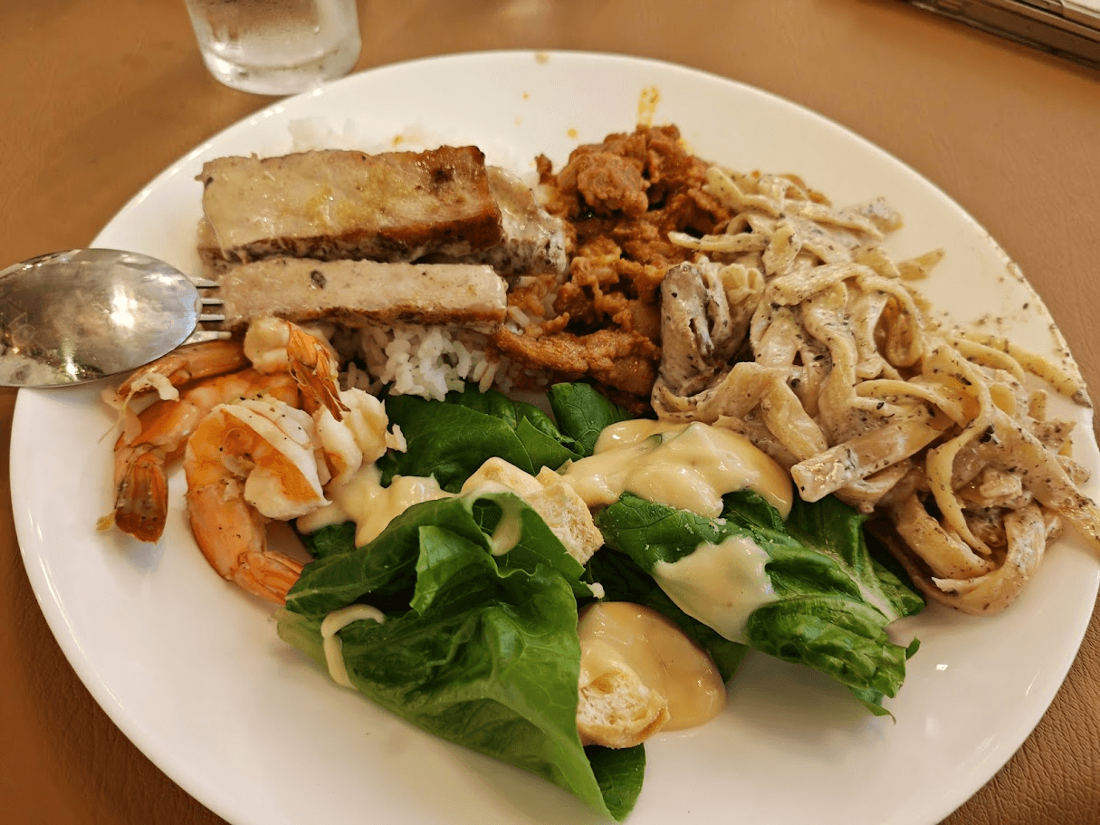 Buffet plate with bulgogi, prawns, salad, pasta