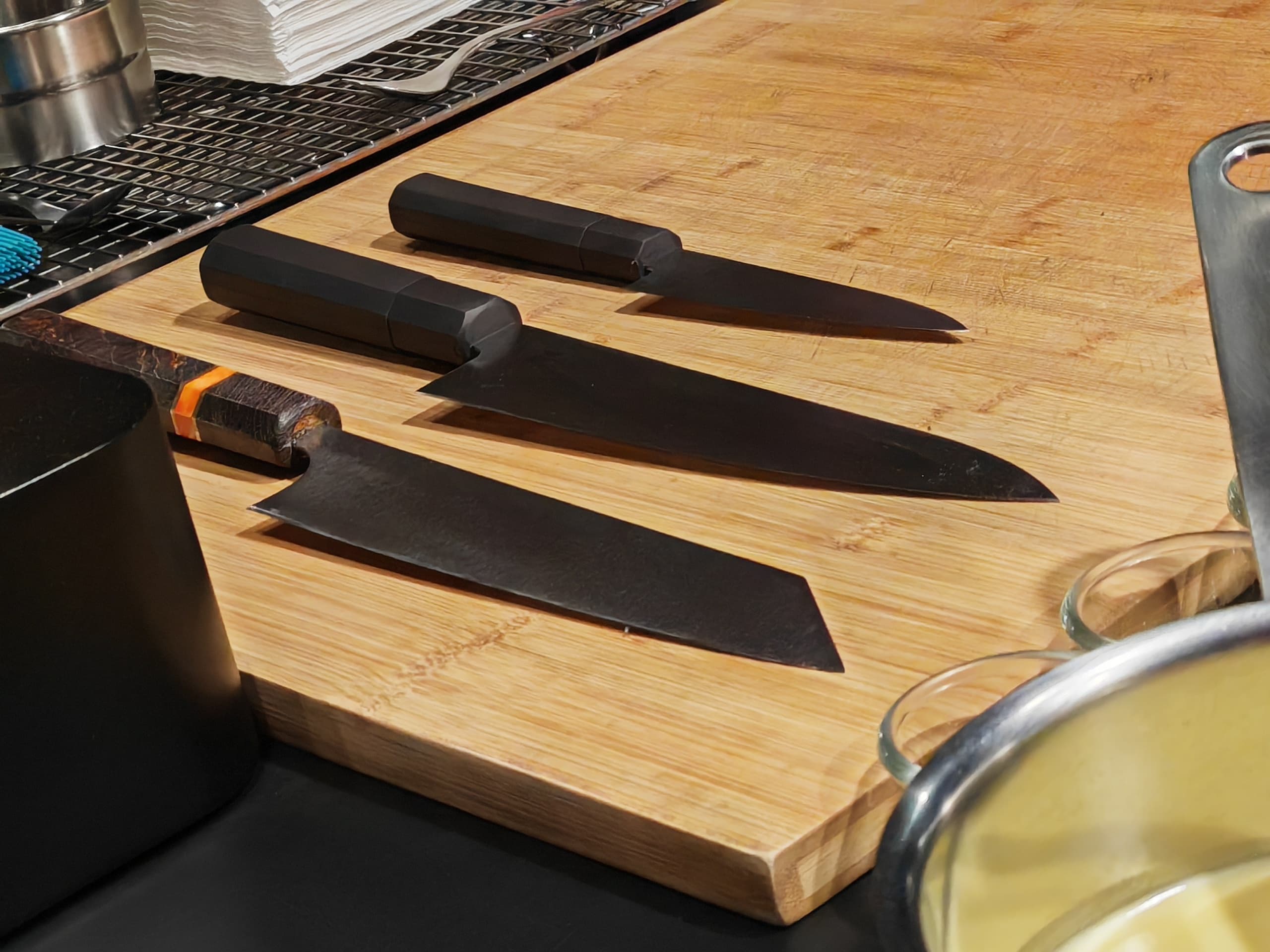 Chef Taiki's knife collection on a wooden board